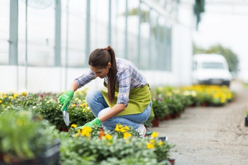 Front view of a gardener at work with tools and plants